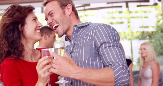 Happy couple celebrating with champagne at a party