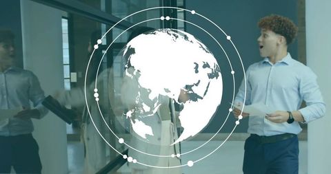 Holding papers, young professional reacting with digital globe hud in glass corridor