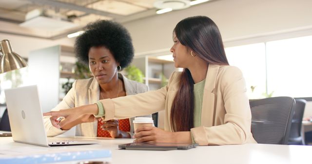 Two Professional Women Collaborating on Laptop at Office - Download Free Stock Images Pikwizard.com