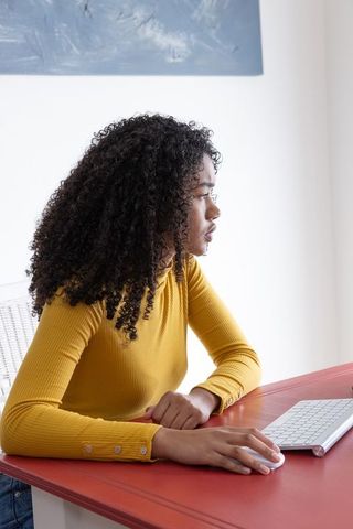 Focused African American Woman Working at Stylish Desk with Vibrant Decor