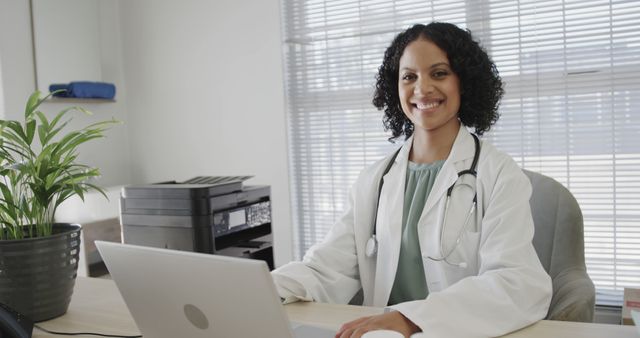 Smiling Female Doctor Using Laptop in Modern Office - Download Free Stock Images Pikwizard.com