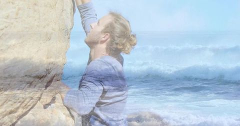 Climber conquering sandstone cliffs near ocean