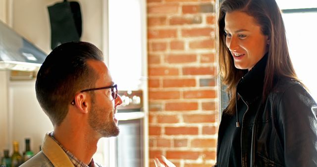 Cheerful Couple Talking in Cozy Kitchen with Exposed Brick Walls - Download Free Stock Images Pikwizard.com