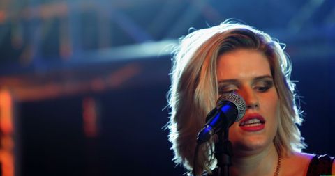 Young Woman Singing Passionately On Stage During Live Music Performance - Download Free Stock Images Pikwizard.com
