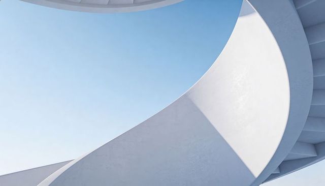 Minimalist Curving White Spiral Ramp with Sharp Triangle Shadow under Clear Blue Sky