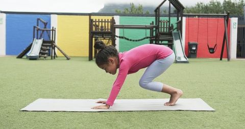 Young Hispanic Girl Practicing Yoga in School Playground