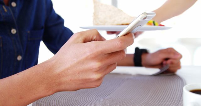 Person Using Smartphone While Dining in Casual Restaurant - Download Free Stock Images Pikwizard.com