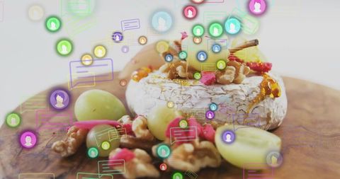 Showcasing ripened cheese wheel with honey and walnuts on board with floating social icons