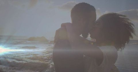 Romantic Kissing Couple on Sunset Shoreline Embracing the Moment
