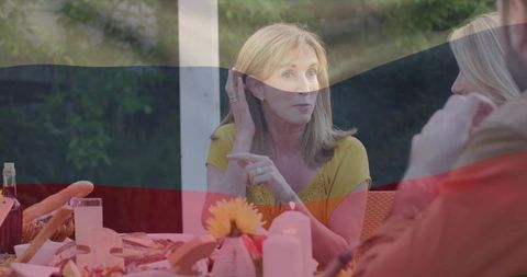 Family sharing meal on sunlit outdoor patio