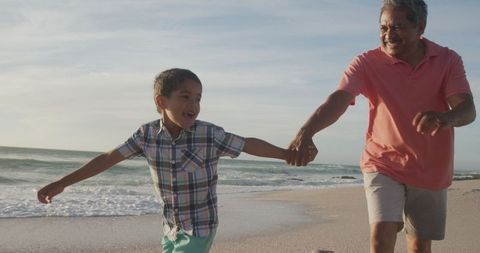 Joyful Grandfather and Grandson Bonding on Scenic Beach Shore