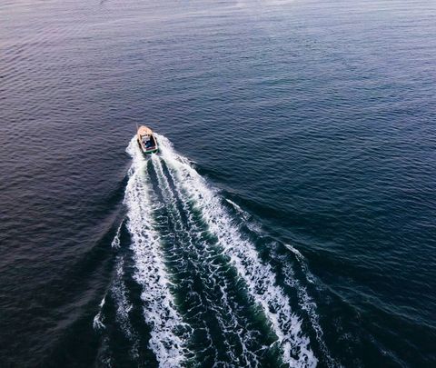 Aerial View of Boat Creating White Wake on Tranquil Ocean