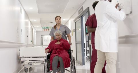 Nurse Attending to Elderly Patient in Hospital Corridor - Download Free Stock Images Pikwizard.com
