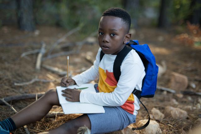 Portrait of boy studying in forest - Download Free Stock Photos Pikwizard.com
