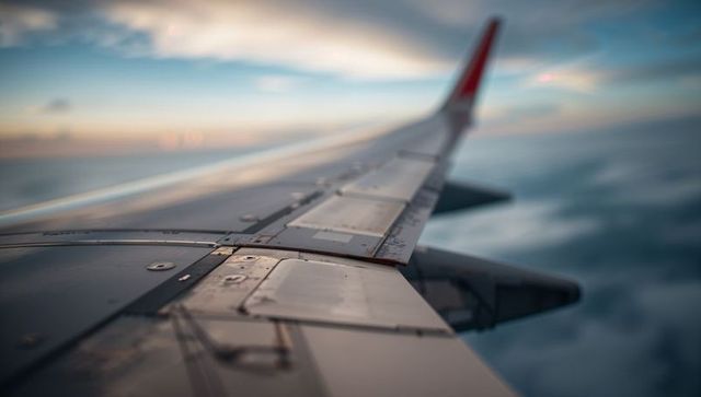 Airplane Wing in Flight Overclouds at High Altitude