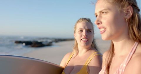 Friends Enjoying a Sunny Day at the Beach with Surfboards in Hand