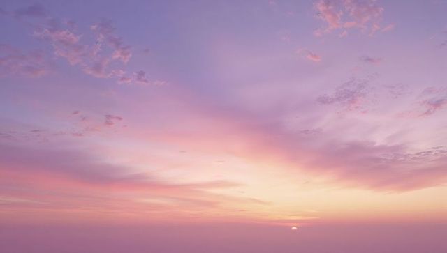 Peaceful Pastel Sky at Sunrise with Soft Clouds