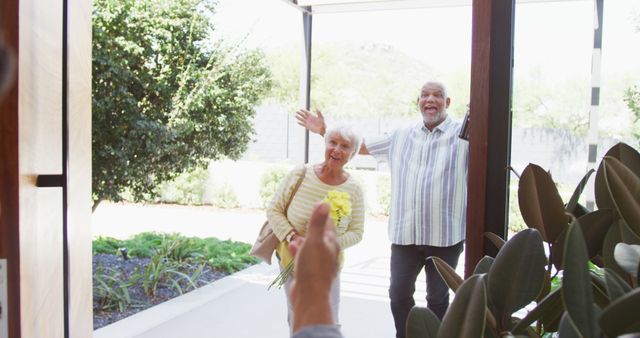 Happy senior biracial couple opening door at retirement home. healthy, active retirement and body inclusivity.