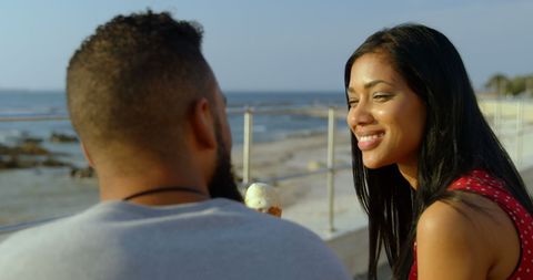Interracial Couple Enjoying Ice Cream Seaside on Sunny Day