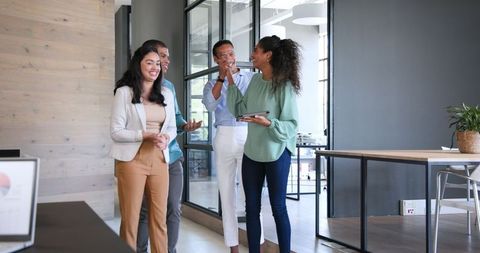 Diverse Colleagues Celebrating Success in Modern Office Environment