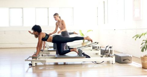 Women Practicing Pilates on Reformers in Bright Studio - Download Free Stock Images Pikwizard.com
