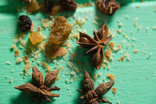 Close-Up of Star Anise and Dried Fruits on Green Surface - Download Free Stock Photos Pikwizard.com