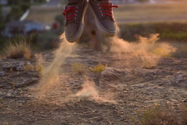 Person Jumping on Dusty Trail at Sunset - Download Free Stock Photos Pikwizard.com