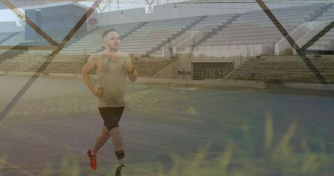 Athlete with Prosthetic Blade Running on Track in Empty Stadium