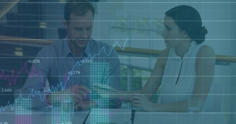 Caucasian Business Team Analyzing Graphs with Data Overlay