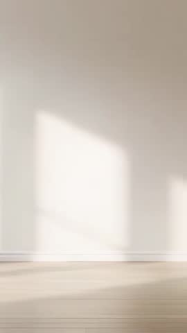 Vertical time-lapse of sunlight sliding across neutral wall and light wood floor