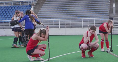 Disappointed caucasian female hockey players reflect on defeat