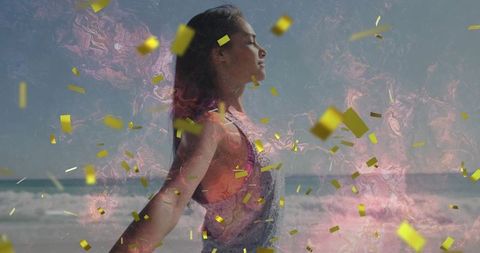 Carefree woman at beach amongst golden confetti and pink swirls