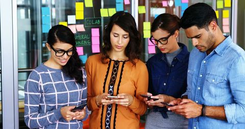 Modern Workforce Engaging with Smartphones in Office Meeting - Download Free Stock Images Pikwizard.com