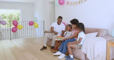 Family Birthday Celebration with Colorful Cake at Home