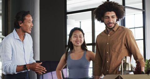 Diverse Colleagues Greeting with Handshake in Office Environment