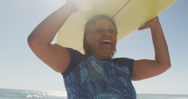 Senior Woman Carrying Surfboard on Sunny Beach - Download Free Stock Images Pikwizard.com