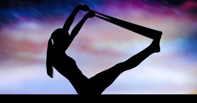 Silhouette of a woman practicing yoga with a resistance band against a colorful sky background. Ideal for use in fitness and wellness blogs, yoga class promotions, meditation guides, and health-related articles. The image conveys themes of strength, flexibility, balance, and tranquility.