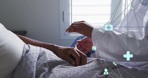 Nurse holding patient hand at bedside showing compassion with telemedicine network overlay