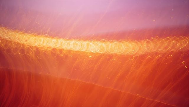 Glowing gold bokeh band with cascading orange light trails and soft purple gradient