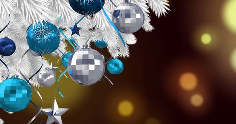 Festive Blue and Silver Christmas Decorations on White Tree
