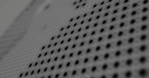 Macro perforated metal panel with diagonal hole pattern and matte scratched surface