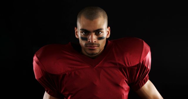 Determined American Football Player in Red Uniform Against Dark Background - Download Free Stock Images Pikwizard.com