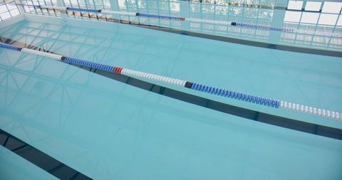 Serene swimming pool with reflective waters and lane dividers