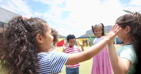Children Playing Outside in Schoolyard on Sunny Day