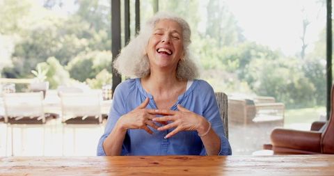 Joyful Senior Woman Expressing Gratitude at Home