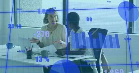 Colleagues Discussing Analytics in Modern Meeting Room