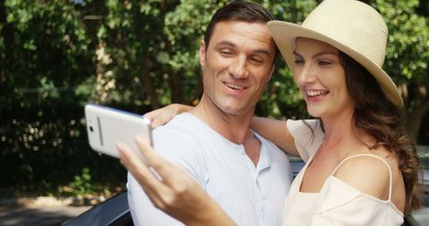 Happy Couple Taking Smiling Selfie Outdoors