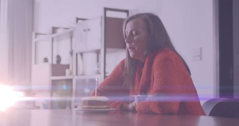 Lonely woman with birthday cake on loneliness awareness day