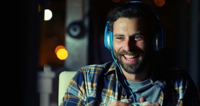 Man Enjoying Gaming with Headphones in Cozy Night Environment - Download Free Stock Images Pikwizard.com