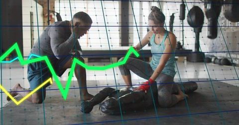 Coach teaching hands-only cpr on mannequin in gym with data overlay for training